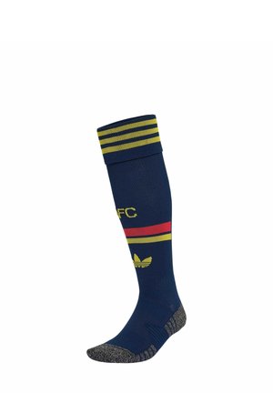 Calcetín alto azul marino con rayas amarillas y rojas, letras amarillas AFC, logo amarillo de Adidas y áreas grises texturizadas en la puntera y el talón.