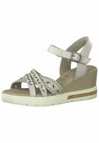 Wedge-Sandalen aus hellgrauem Leder mit ausgeschnittenen Blattmustern, verstellbarem Knöchelriemen und strukturiertem Keilabsatz mit Korkakzent.