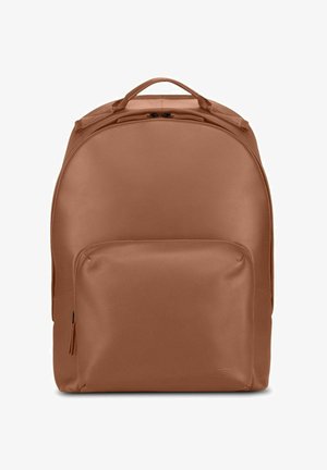 Brown leather backpack with a rounded design, a front zippered pocket, and top handle. Smooth texture, minimal hardware details.