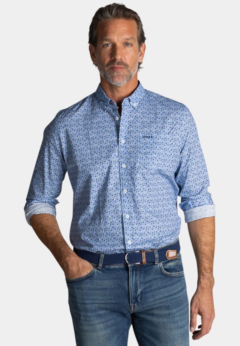 lichtblauw overhemd met knopen en een gepattern ontwerp, met opgerolde lange mouwen, gecombineerd met blauwe jeans en een geweven marineblauwe riem.
