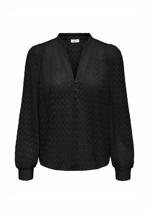Blouse noire à manches longues avec motif hexagonal texturé, patte de boutonnage à trois boutons, décolleté en V et manches avec poignets.