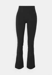 Leggings de sport noirs évasés avec une taille haute. Fabriqués en tissu extensible, présentant une texture lisse et une construction sans coutures.