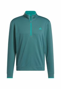 Teal pullover dengan kerah setengah zipper, lengan panjang, dan kain tekstur. Memiliki aksen teal muda di kerah dan manset. Logo di dada.