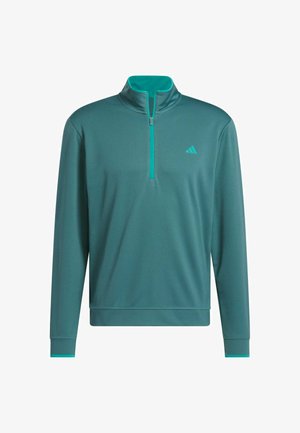 Cyan pullover met een halve rits kraag, lange mouwen en textielstof. Kenmerkt zich door een licht cyan accent bij de kraag en manchetten. Logo op de borst.