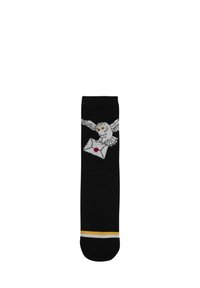 Calze nere con un motivo decorativo di un gufo bianco che porta una lettera, con un sigillo rosa e strisce gialle e bianche al polsino.