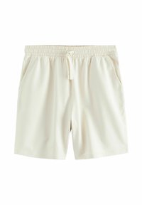 Pantalones cortos color beige claro, confeccionados en una tela suave, con una cintura elástica y cordón ajustable, además de dos bolsillos laterales. Diseño liso y simple.