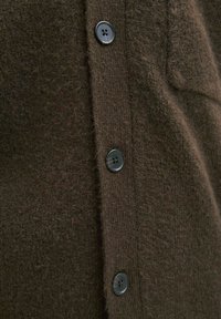 Brown wool cardigan featuring a textured finish and six black buttons along the front, with a ribbed button placket for added detail.