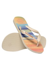Tongs légères avec une semelle intérieure à rayures multicolores, des sangles en caoutchouc beige et une semelle extérieure texturée blanche. Avec un logo en relief.