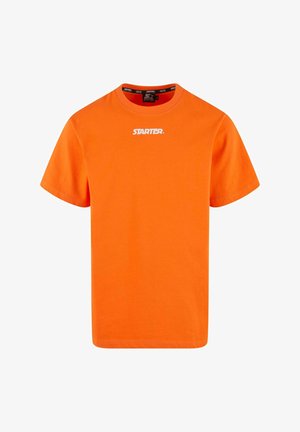 Oranssi puuvillapaita lyhyillä hihoilla. Edessä on valkoinen "STARTER." logo keskellä rintaa. Klassinen pyöreä pääntie.