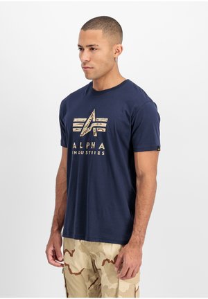 Navy blue t-shirt made of cotton with short sleeves, featuring a camouflage-patterned logo on the front and a small emblem on the sleeve.