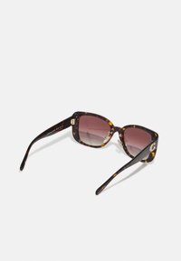 Tortoiseshell sunglasses with a square shape, gradient lenses, and gold hardware accents. The frame features a glossy finish and decorative hinges.