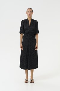 Black midi dress with short puff sleeves, deep V-neck, and ruched detailing at the waist, featuring a subtle textured pattern.