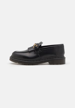 Schwarze Lederloafers mit runder Zehenform, dekorativem Fransenbesatz und goldenen Hardware-Akzenten. Dicke Gummisohle für zusätzlichen Halt und Strapazierfähigkeit.