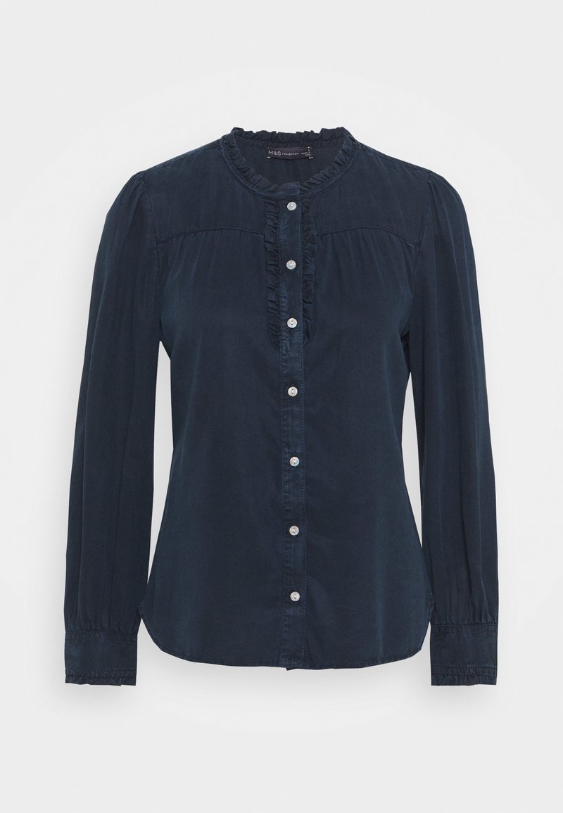 Camicia blu navy con bottoni, maniche lunghe, dettagli arricciati lungo il collo e colletto rotondo. Realizzata in tessuto lucido e liscio.
