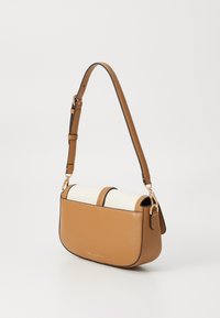 Brown leather crossbody bag with a top flap featuring a cream fabric. Adjustable shoulder strap and gold-tone hardware accents.