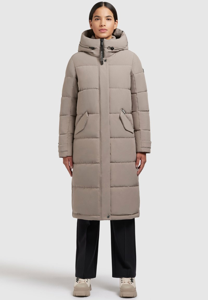 Lang, polstret frakke i lys grå, med hætte, brystlynlås, to forlommer og lige pasform. Glat tekstur med kviltet design.