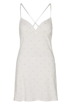 White slip dress with thin crossed straps and small blue floral pattern throughout.