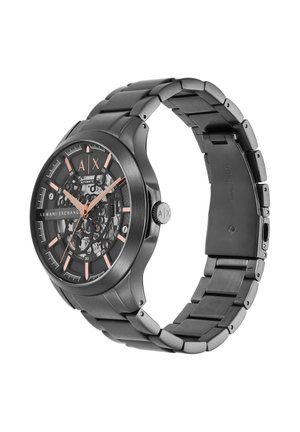 Zwarte automatische herenpolshorloge van Armani Exchange met roségouden wijzers en indexen, skeleton-wijzerplaat en metalen schakelsluiting.