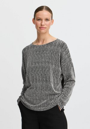 Maglione a maglia texturizzata bianco e nero con scollatura ampia e maniche lunghe, caratterizzato da una vestibilità morbida e un orlo arrotondato.