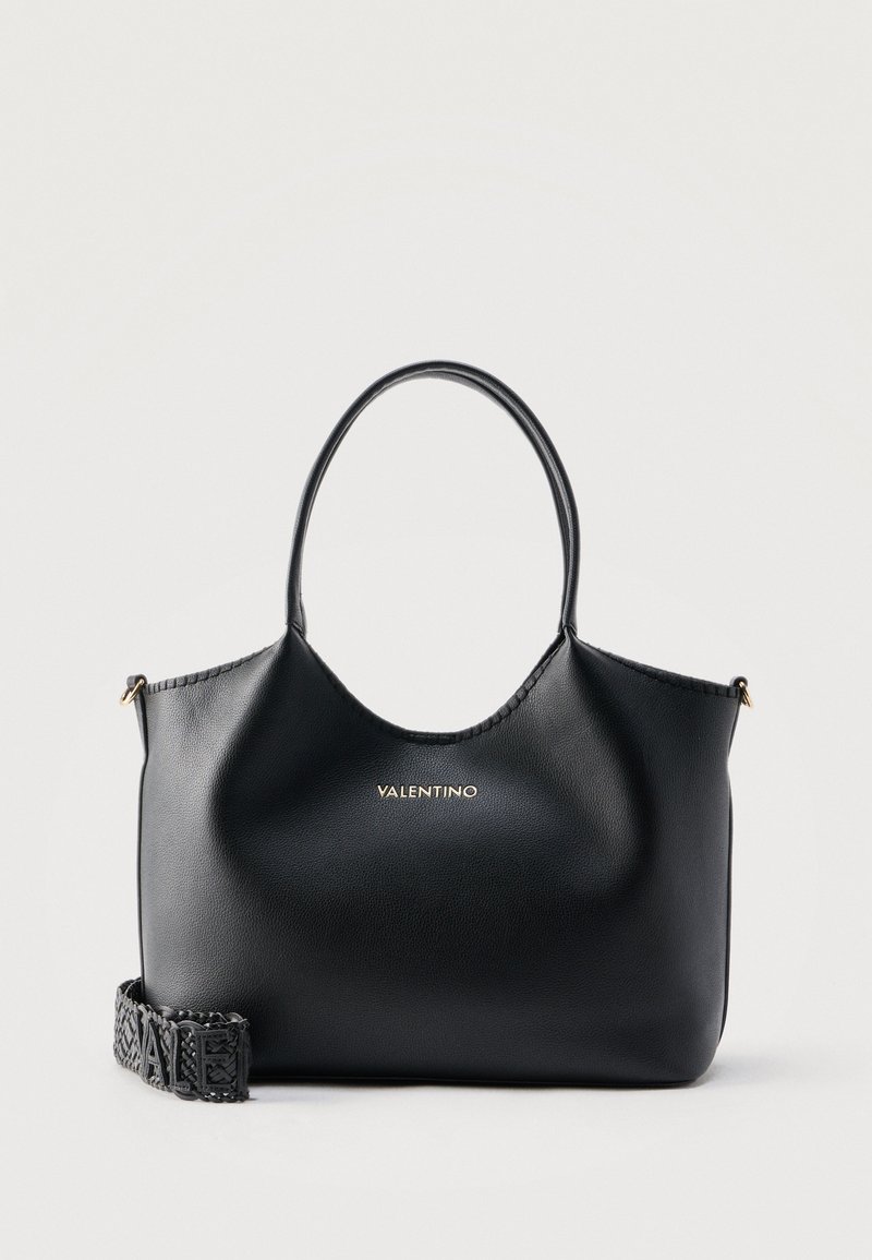 Μαύρη δερμάτινη τσάντα tote Valentino με στρογγυλεμένες λαβές και αποσπώμενο υφαντό ιμάντα με λογότυπο, σε απλό φόντο.