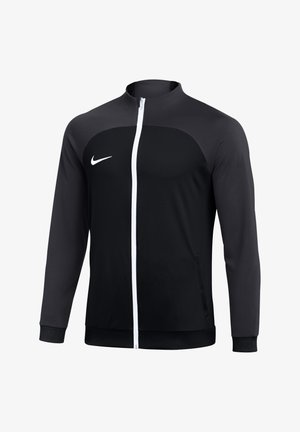 Veste de sport noire et gris foncé zippée avec fermeture éclair blanche et logo Nike blanc sur la poitrine gauche, manches longues et col montant.