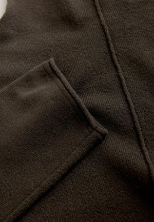 Dark brown sweater fabric with a smooth texture, featuring a front pocket and subtle ribbed detailing along the edges and seams.
