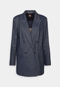 Blazer en jean bleu marine à double boutonnage avec larges revers, quatre boutons noirs, deux poches à rabat à l'avant et manches longues.