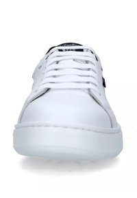 Zapatilla blanca con parte superior de cuero suave, punta redonda y suela plana de goma. Presenta cordones y un sutil logotipo en la lengüeta.