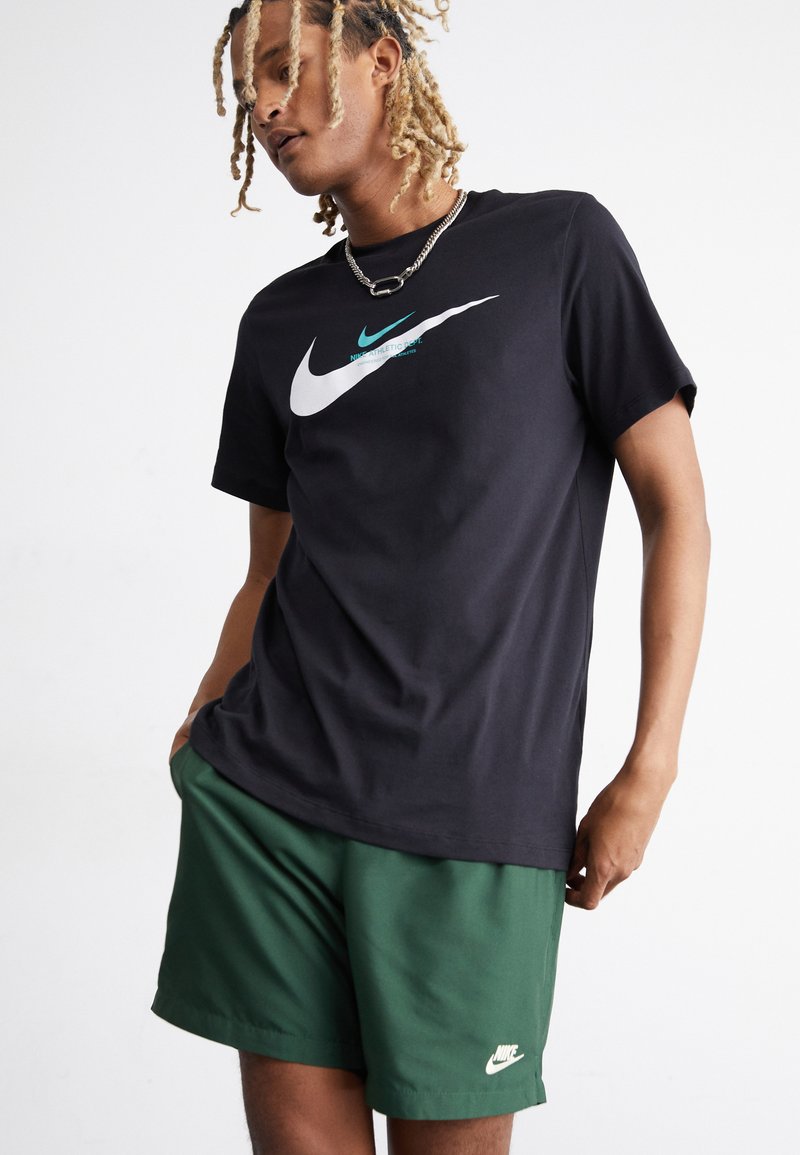 Nike Sportswear FLOW - Pantaloni sportivi - fir