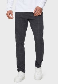 Gray plaid pants made of woven fabric, featuring a slim fit, flat front, and subtle texture. Worn with white sneakers.