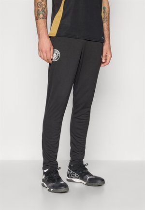 Sorte træningsbukser med slim fit, med et Manchester City-logo på låret, lavet af let, struktureret materiale.