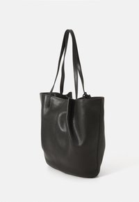 Borsa tote in pelle nera con superficie texturizzata, struttura morbida, due manici lunghi e apertura superiore. Presenta elementi di design minimalista.