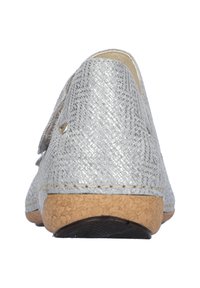 Zilveren geweven instapschoen met een gestructureerd oppervlak, kurken zool en een licht verhoogde hak; heeft een ronde neus en geen zichtbare hardware.