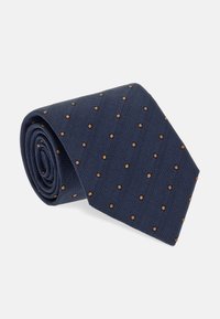 Corbata azul marino con tejido texturizado y lunares marrón claro espaciados uniformemente, con extremo cónico y exhibición enrollada.
