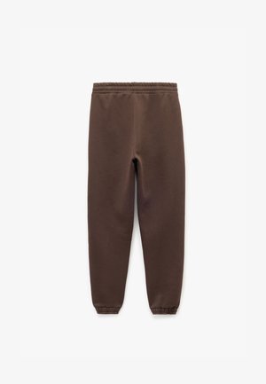 Zwarte sweatpants met een elastische tailleband, taps toelopende benen en ribgebreide boorden, gemaakt van een zachte, gestructureerde stof.