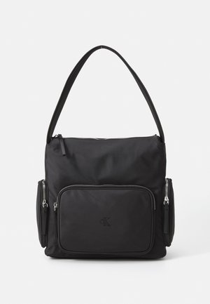 Black nylon shoulder bag with a zippered top, front pocket, and two side zip pockets. Features a smooth texture and an embossed logo.