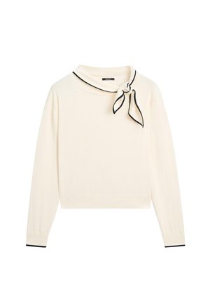 Kremfarvet langærmet sweater med et lille sortkantet halstørklæde bundet på højre side og matchende sort kant ved ærmekanterne.