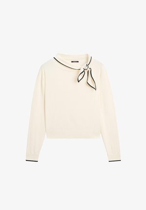 Cremefarbener Pullover mit langen Ärmeln, einem kleinen schwarzen Halsband mit schwarzem Besatz, das auf der rechten Seite gebunden ist, und passenden schwarzen Rändern an den Bündchen.