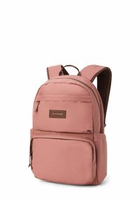 Mochila de tela rosa con forma rectangular, que cuenta con un bolsillo frontal, correas de hombro acolchadas y un asa en la parte superior. Detalles en marrón y logo.