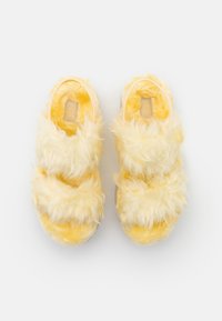 Yellow fluffy slide sandals with two wide bands, soft texture, and a cushioned footbed. Features a logo on the insole.