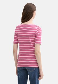 Pink and white striped short-sleeve t-shirt with a rounded neckline; made of soft fabric. Back view shows a fitted silhouette, seamless hem.