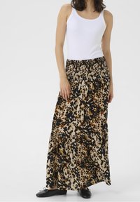 Maxi skirt in leopard print, featuring a smocked waistband, tiered design, primarily tan with black and brown accents, soft fabric.