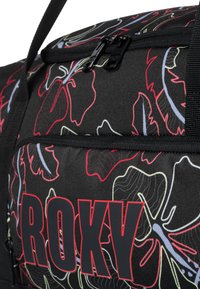 Black duffel bag featuring colorful floral patterns, thick straps, zippered closures, and the brand name "ROXY" in bold red lettering.