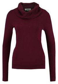 Maglione color bordeaux a collo alto con maniche lunghe, orlo a coste e tessuto morbido. Realizzato in maglia, offre una silhouette aderente.