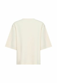 Krémové oversized tričko s voľným strihom, krátkymi rukávmi a okrúhlym výstrihom; vyrobené z mäkkej, priedušnej bavlnenej tkaniny.