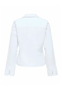 Veste blanche ajustée avec des manches longues, un col pointu et des fentes aux poignets. Texture lisse et lignes épurées.