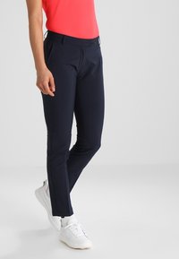 Marinblå skräddarsydda byxor i ett mjukt tyg, med en smal passform, platt front, två sidofickor och ett midjeresår med medelhög höjd.