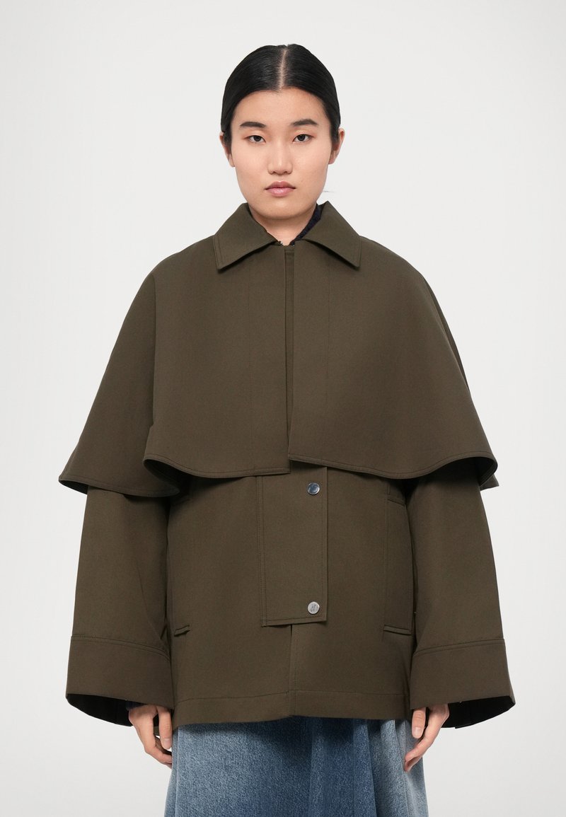 Olive green outerwear featuring a double-layer design, wide sleeves, a collared neck, and button closures at the front.