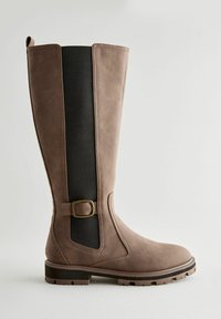 Brown leather knee-high boot featuring a black elastic panel, rounded toe, decorative buckle, and textured sole for traction.