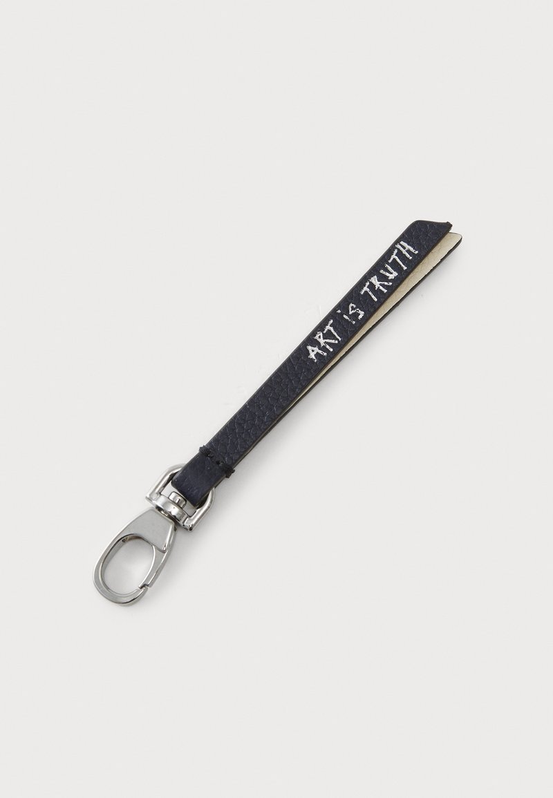 Black leather keychain with a textured finish and silver clip. Features white text reading "ART IS TRUTH" along one side.